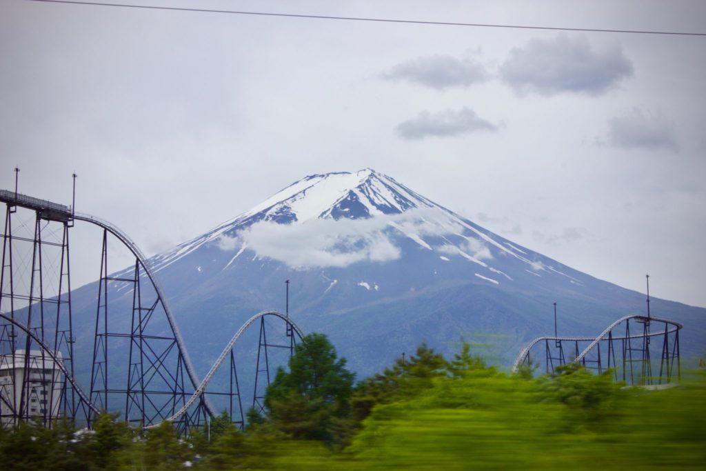 A roller coaster at Fuji Q Highland with Mount Fuji in the background