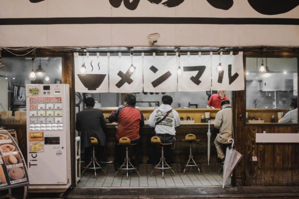 A small Japanese restaurant with a food ticket vending machine right by the entrance