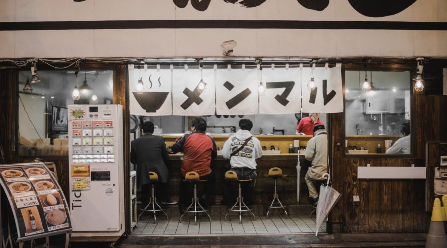 A small Japanese restaurant with a food ticket vending machine right by the entrance